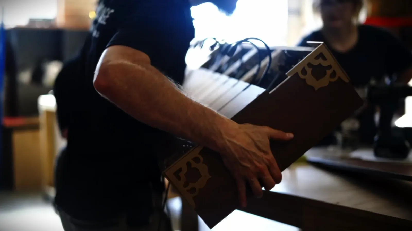 A hand-made escape room prop being carried through the Escape This workshop
